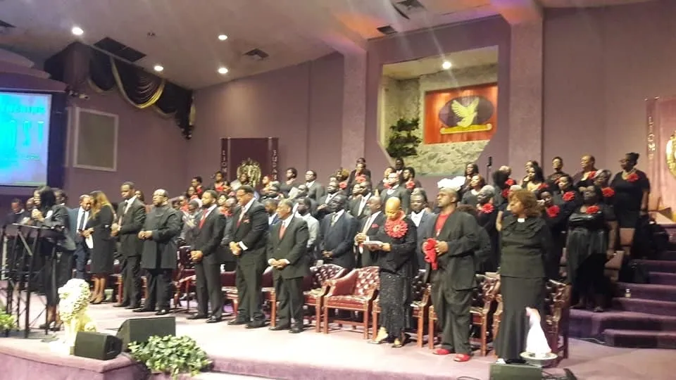 People in black outfit attending the ceremony