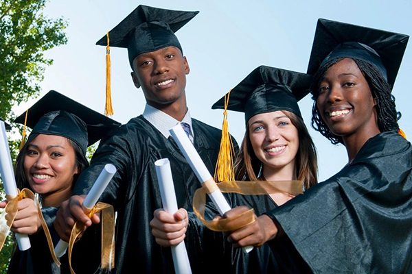 Diverse group of graduates wearing gowns